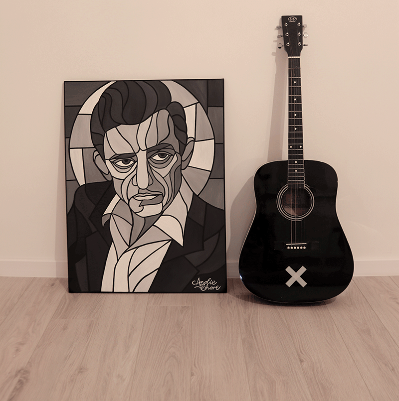Johnny Cash art and black acoustic guitar